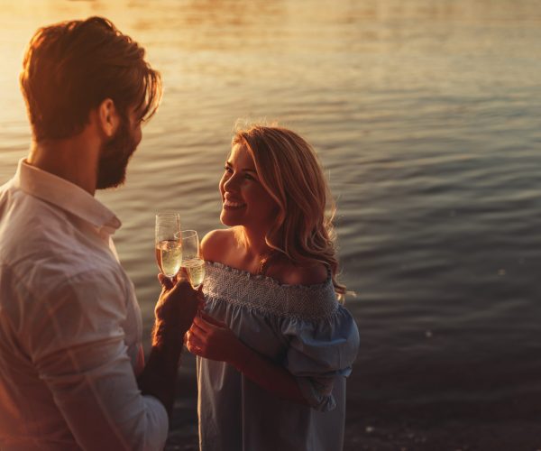 Young couple drinking champagne outdoors